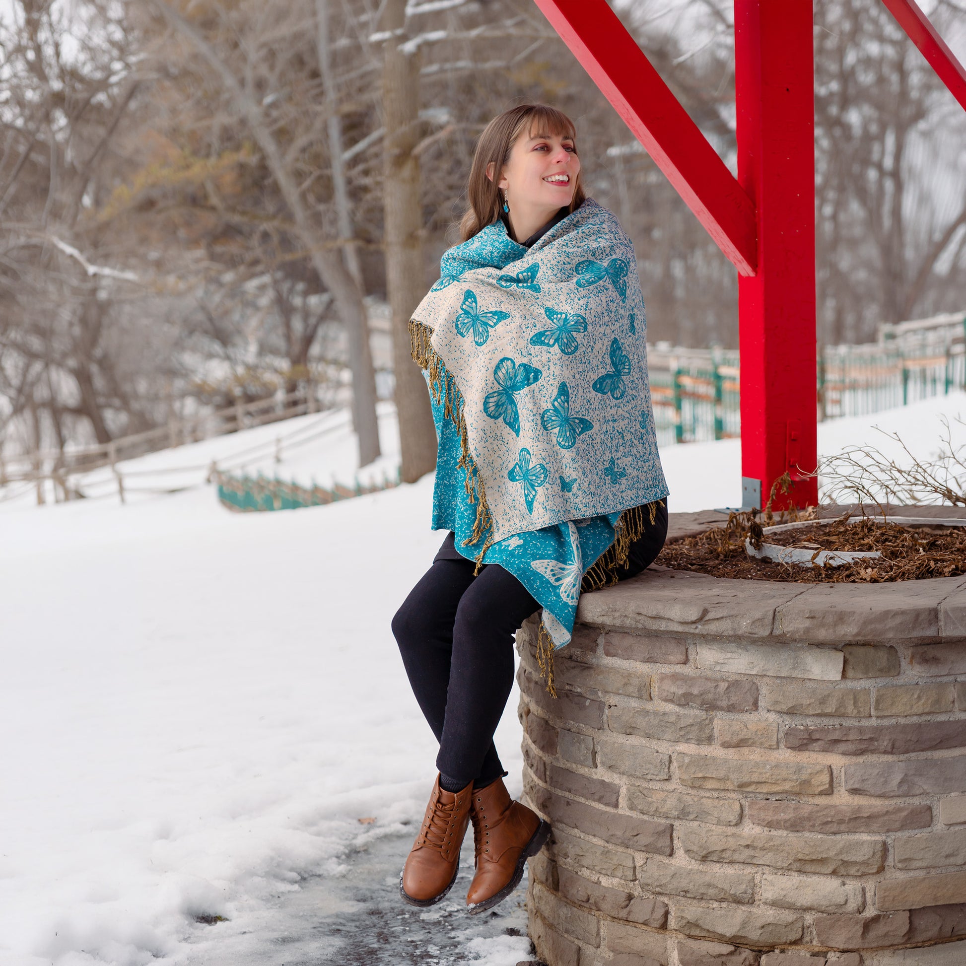 Woman wearing butterfly embroidered shawl with fringe detail reversible artisan fashion Canada