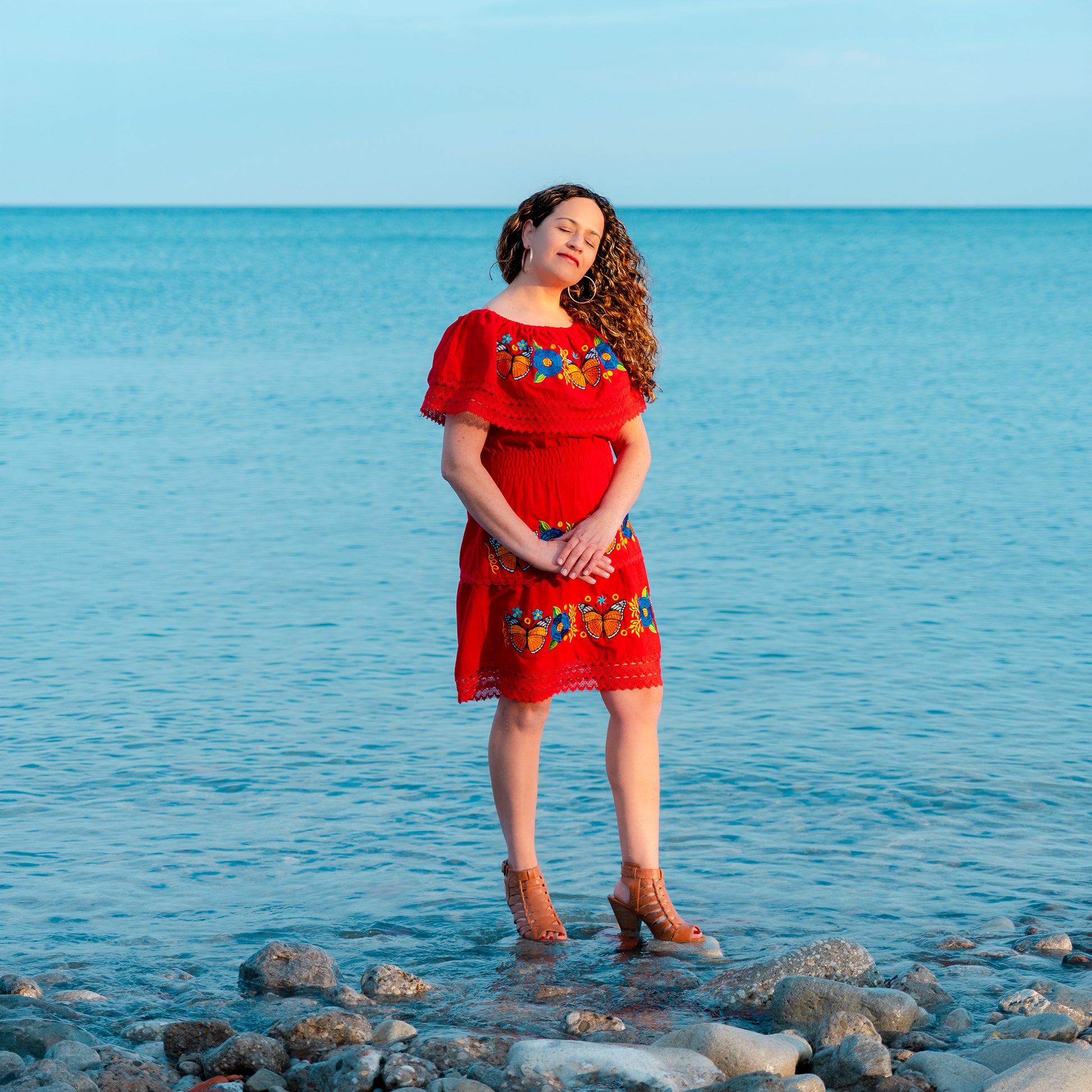 Red off shoulder dress with monarch butterfly embroidery and Mexican artisan floral details