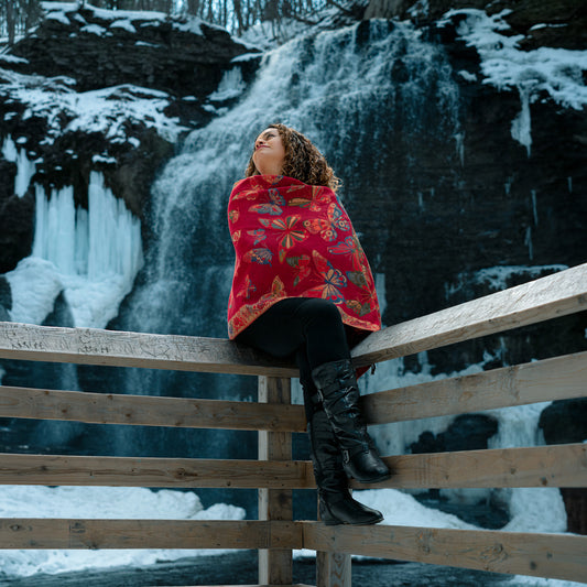 red monarch butterfly reversible shawl worn by woman in winter near waterfall