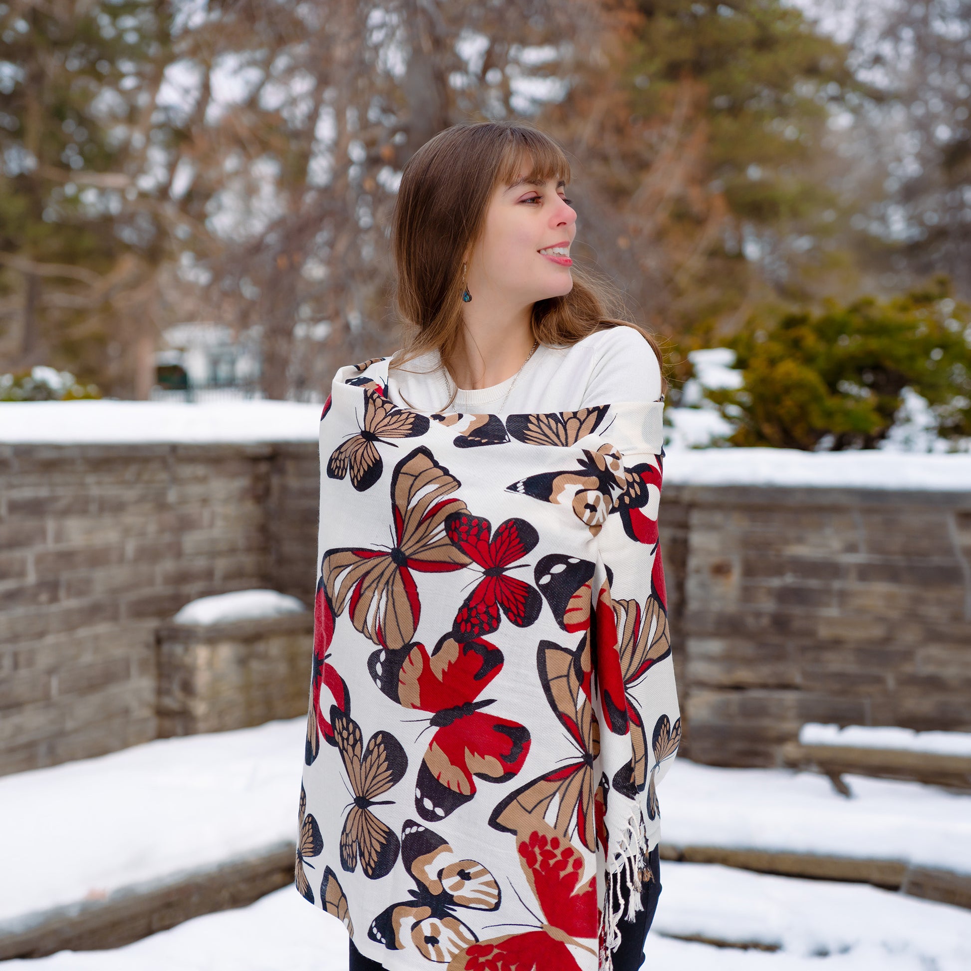 Elegant reversible butterfly shawl with red accents styled in winter setting