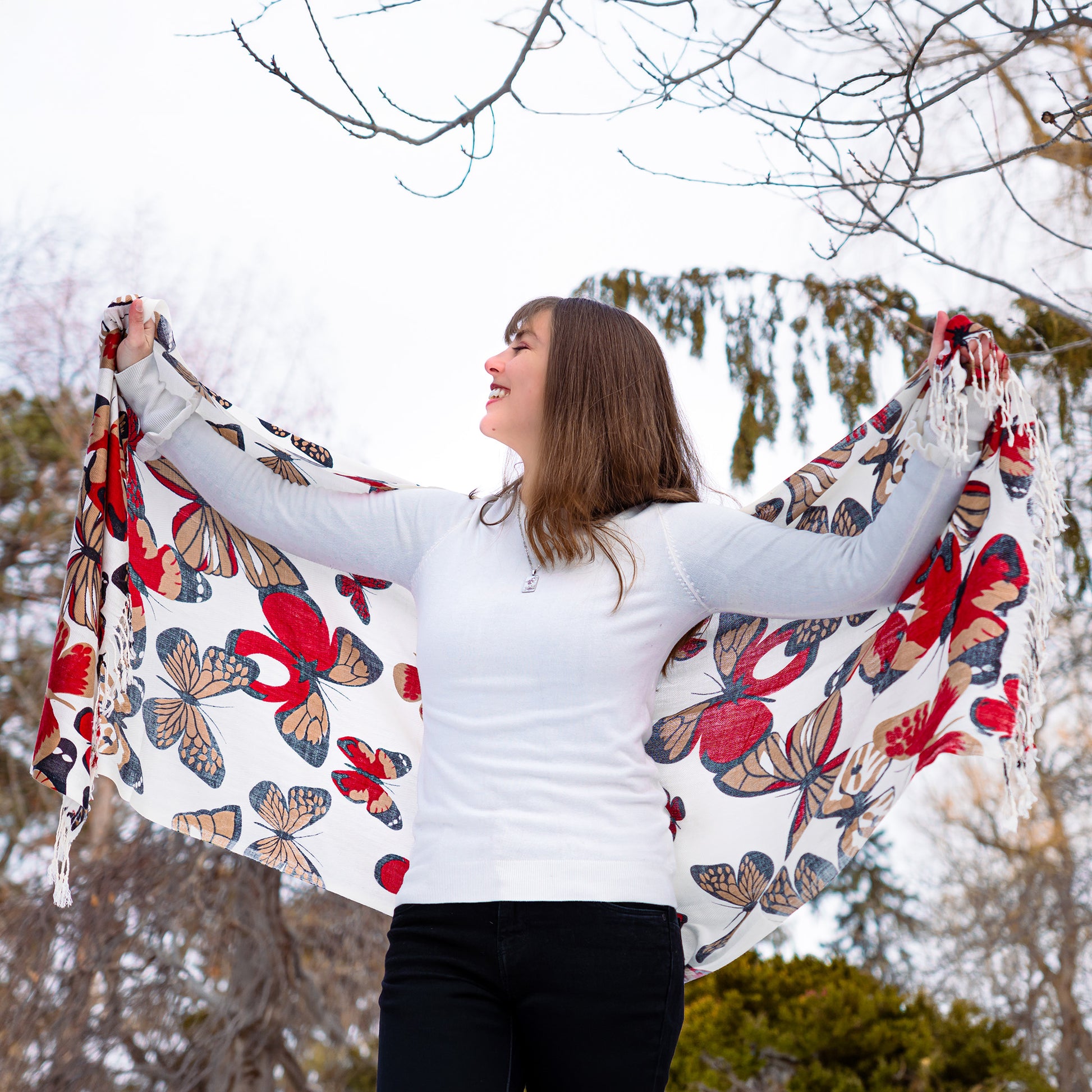 Artisan white shawl with red butterfly patterns and fringe detail