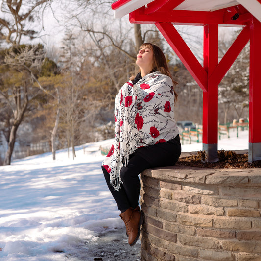 Woman wearing white butterfly embroidered shawl with red floral design elegant winter wrap